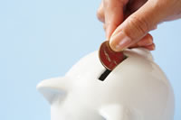 Coin being placed in a piggy bank